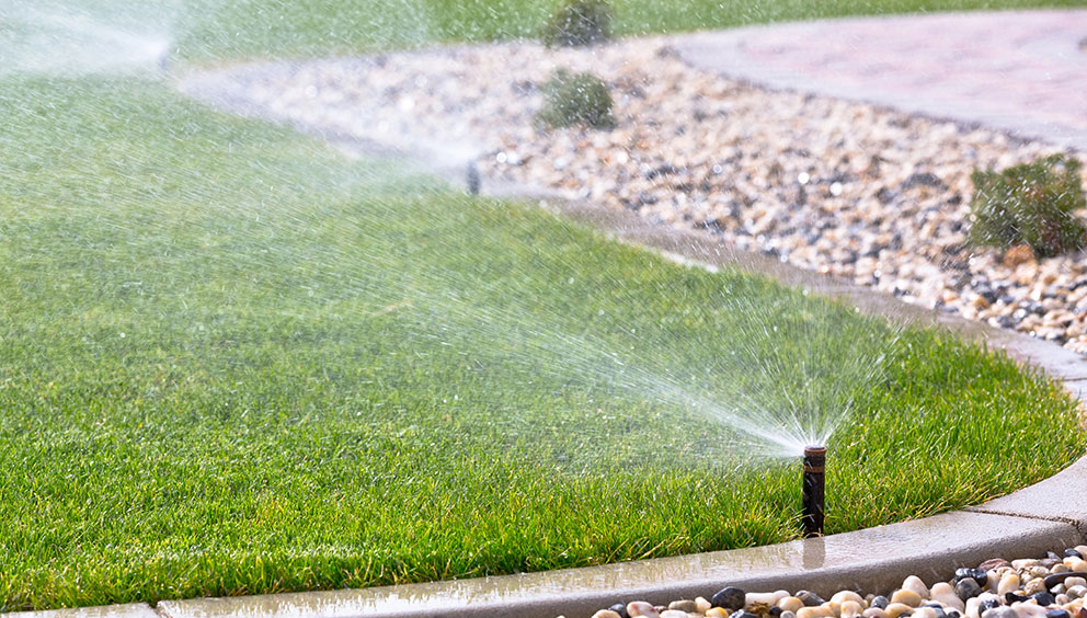 Irrigation sprinklers for commercial property with stone ground cover.