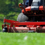 Landscaper mowing commercial lawn.